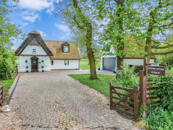 A large white house with a detached garage