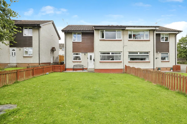 Exterior of a 1960s cottage in North Lanarkshire with a large lawned garden