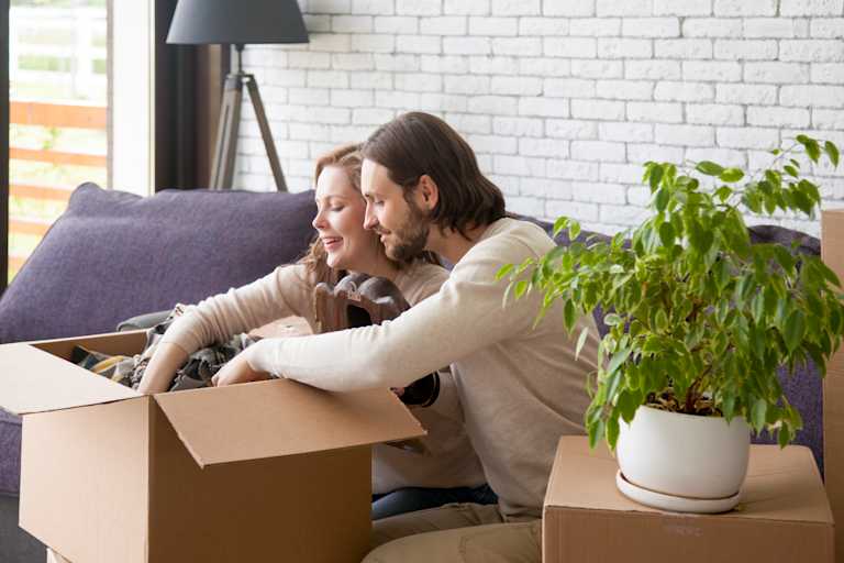 A couple unpacking boxes in their new home