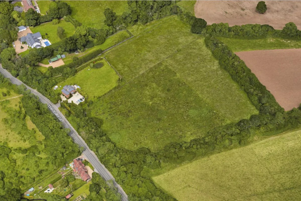 Aerial view of fields and a few houses