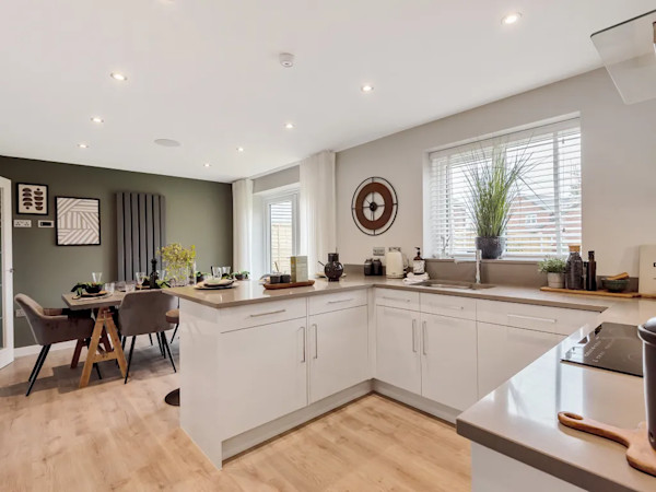 The modern open-plan kitchen-diner of a house available with Rate Reducer