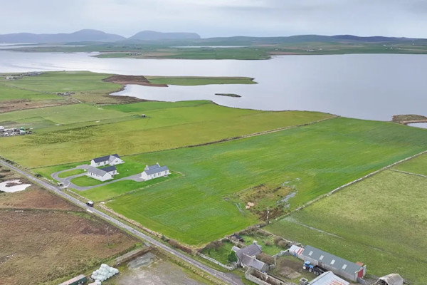 Aerial view that shows the loch and mountains beyond