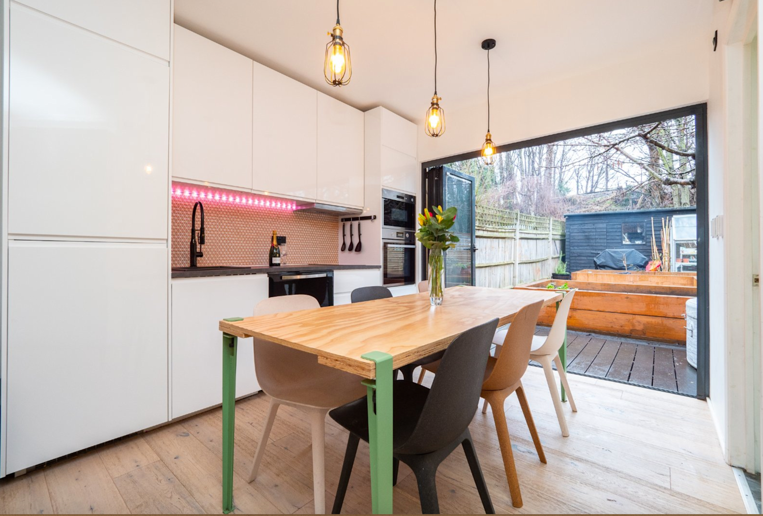 Inside the annexe at the bottom of a family home, with dining area and kitchen and a fold