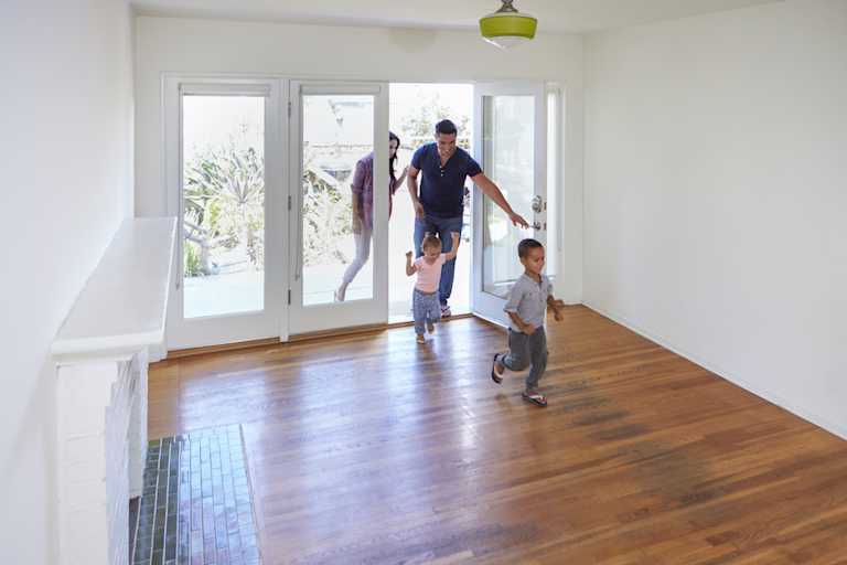 Children running into a new-build home living room