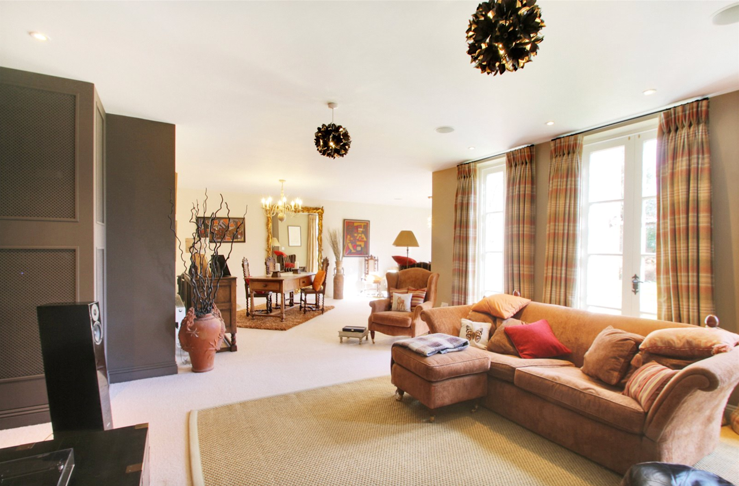 Comfortable interior of a large country house with squashy sofas and neutral tones and walls
