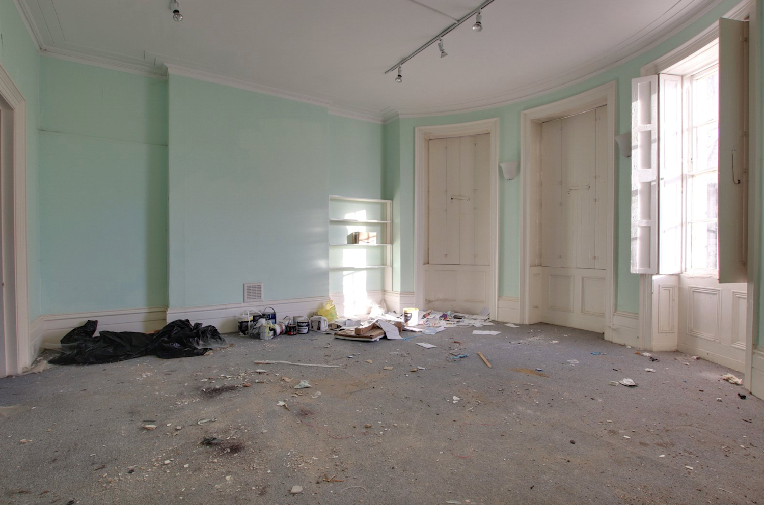 Inside a huge Georgian terraced house in need of renovation, with a number original windows and shutters