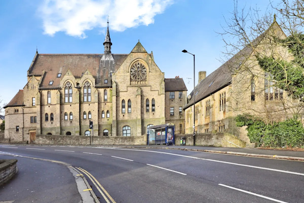 Heritage Hall, a Grade II listed building that dates back to 1881, with a road in front.