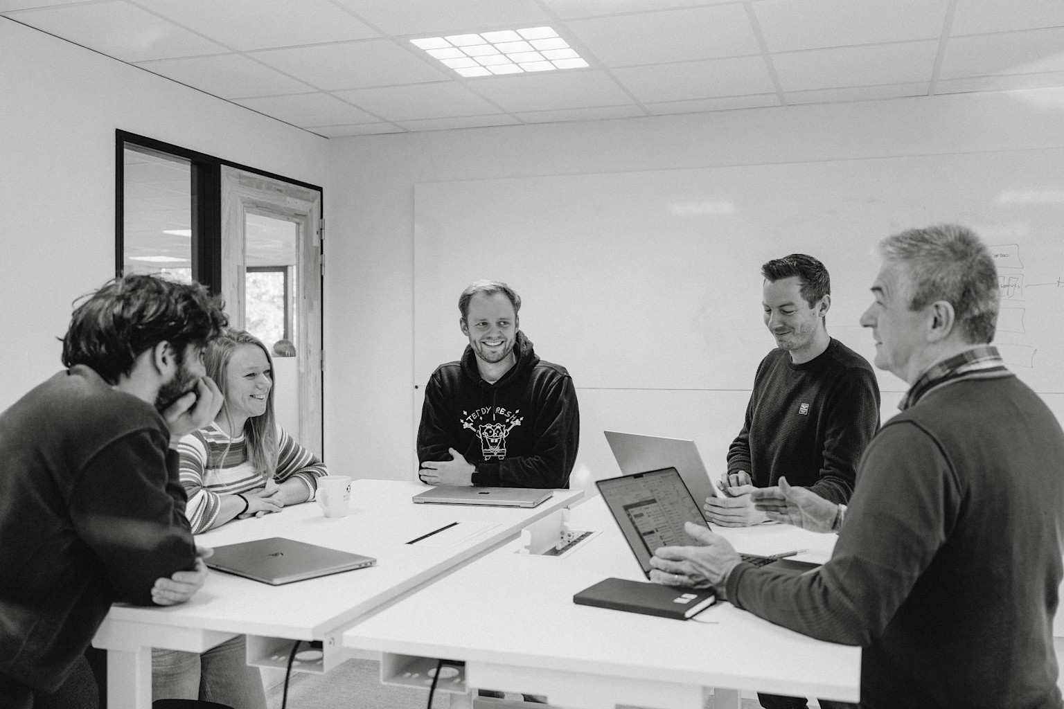 Two developers of the Two Point O team working on our clients' platforms and wearing our Two Point O sweatshirts