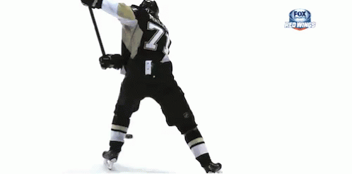 a gif of a hockey player taking a slapshot on goal