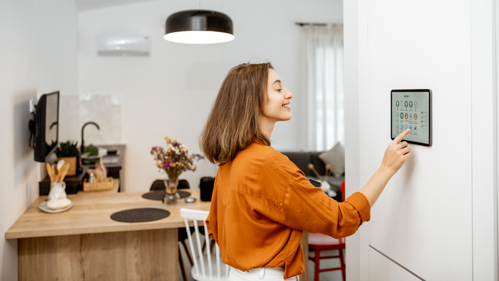 Woman using smart home control panel Smart Iot Device