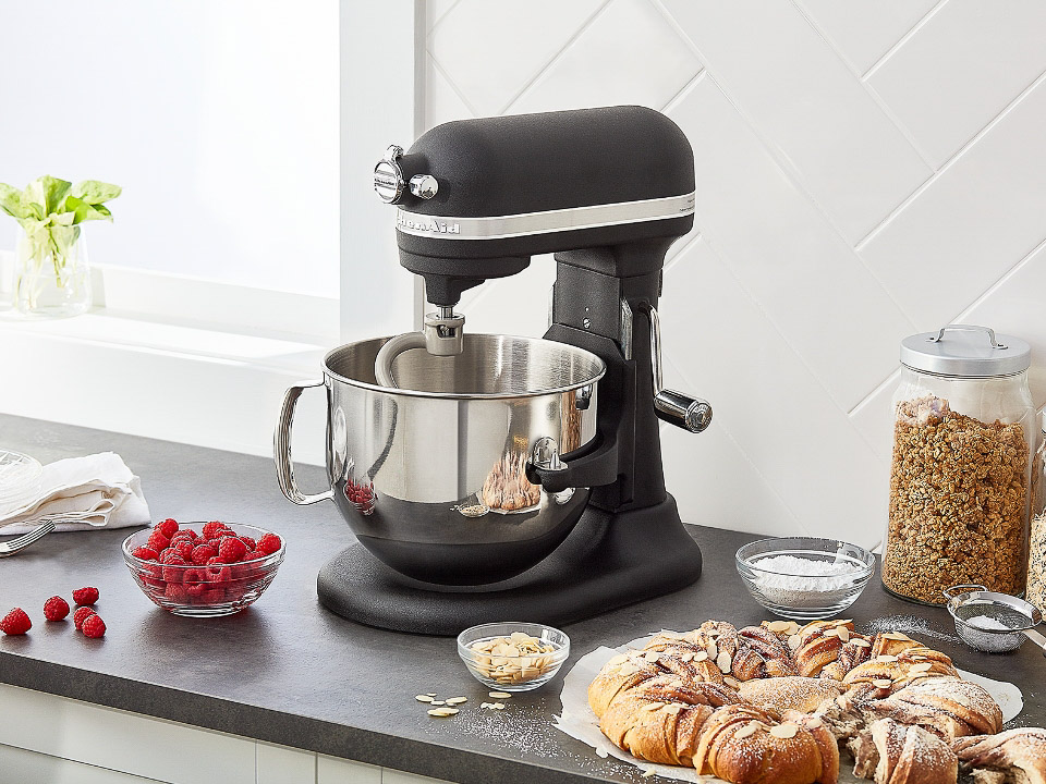 Mixer-parts-dough-hook-stand-mixer-with-dough-hook-next-to-a-bowl-of-raspberries-and-pastry