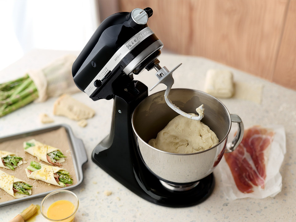 Mixer-parts-dough-hook-stand-mixer-and-dough-hook-next-to-asparagus-in-pastry-on-a-kitchen-counter