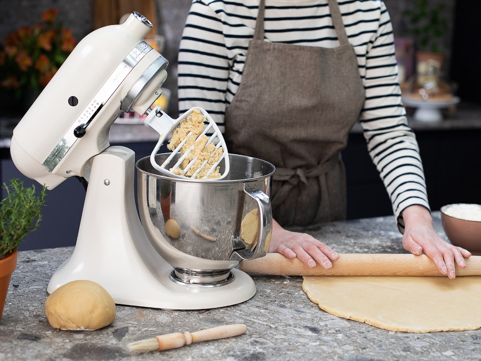 Accessories-pastry-beater-almond-cream-mixer-with-beater-mixing-next-to-woman-in-the-kitchen