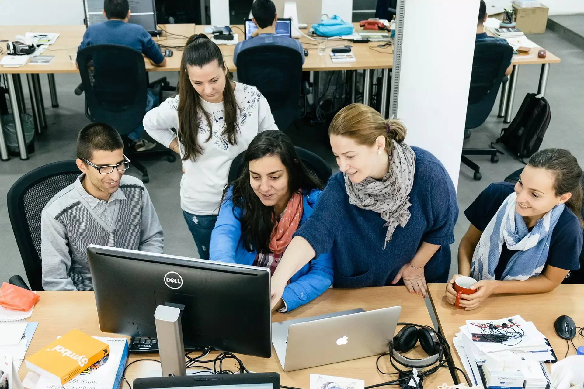 INDUSTRIA's Chief Design Officer, Kalina Dimova, discussing a project with coworkers