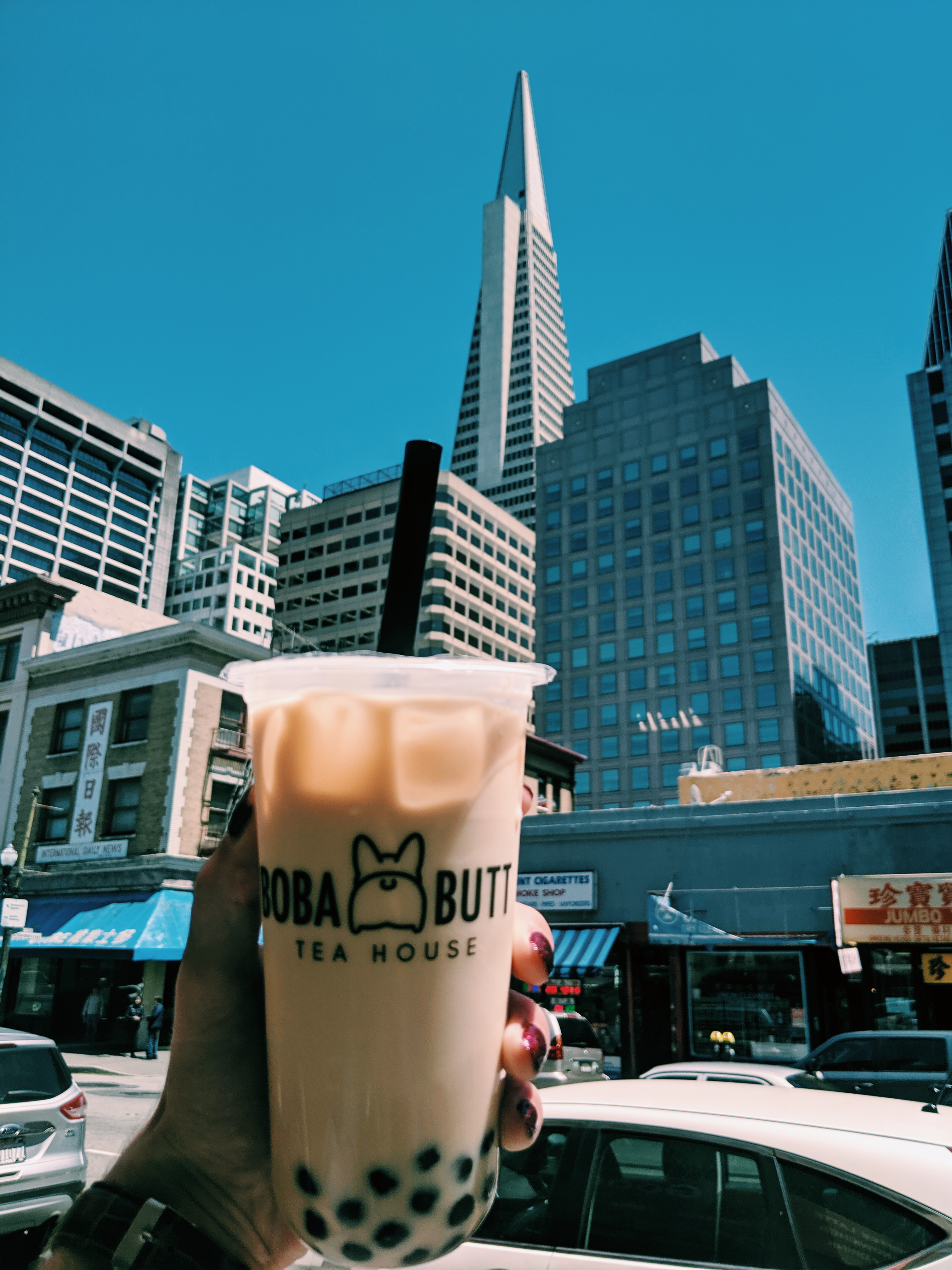 Me holding boba with the iconic Transamerica tower shown in the background.