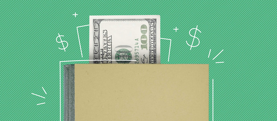 one hundred dollar bill in notebook on green background