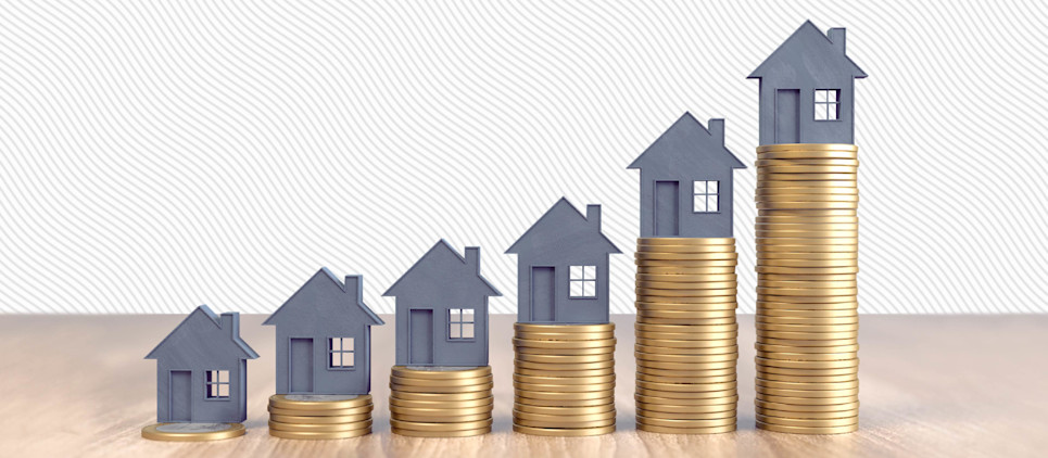 Six grey miniature house figurines on stacks of coins that gradually increase in size.