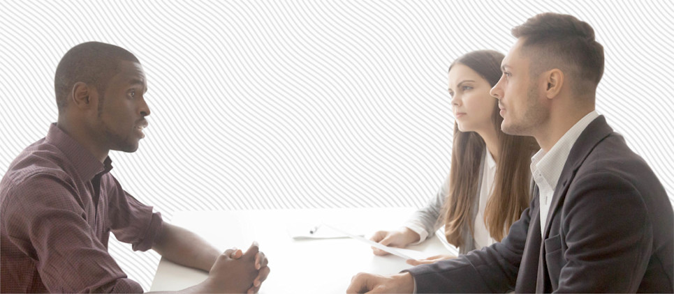 A couple sits across from an advisor.