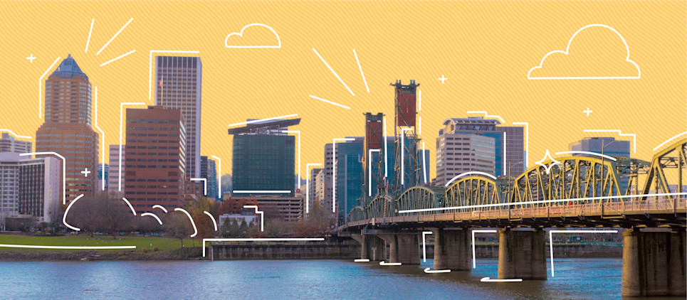 Photo of the city of Portland, OR alongside a river.