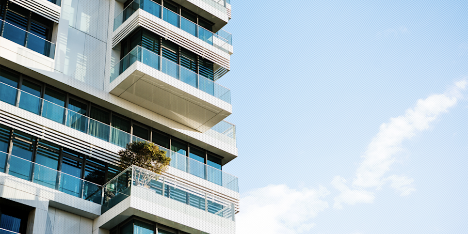A condo apartment set against a light blue sky