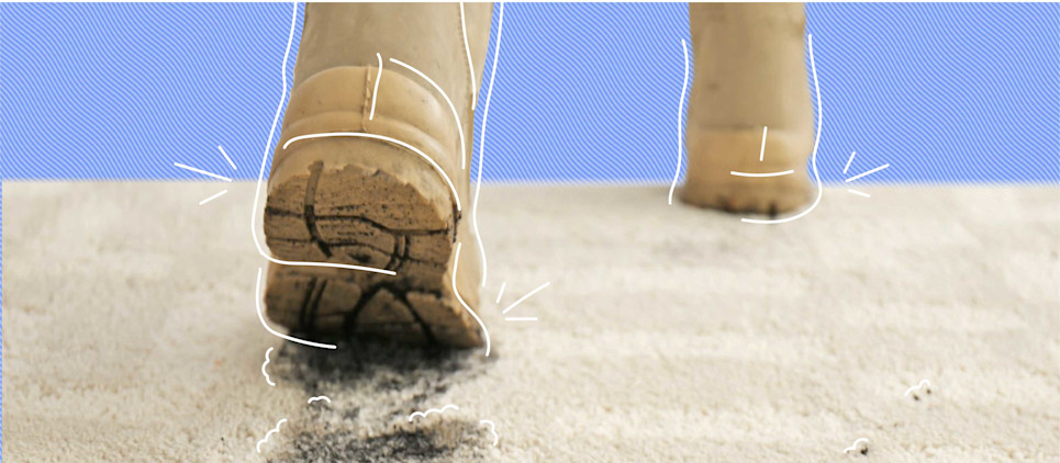 brown muddy boots walking and leaving a stain on a beige rug