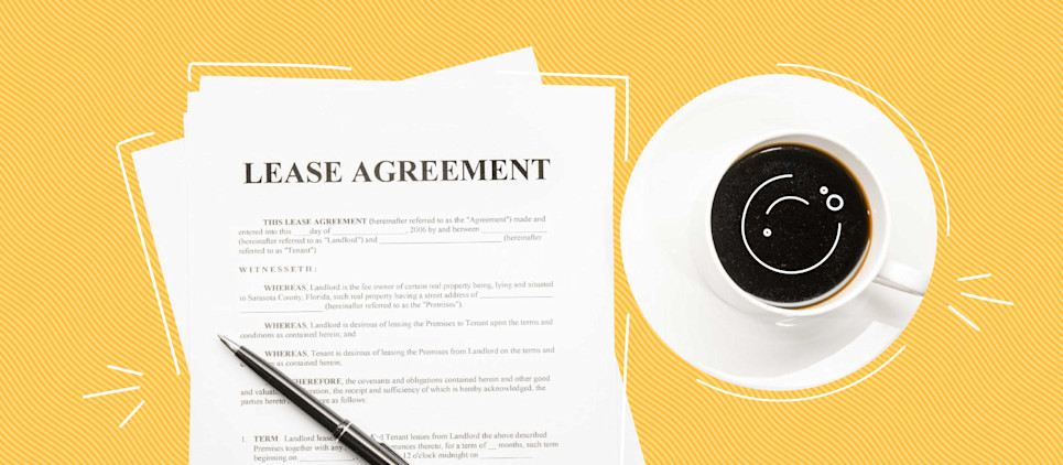 white paper stating lease agreement on yellow background with a cup of coffee to the right of the papers