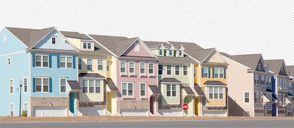 Colorful row houses line a street.