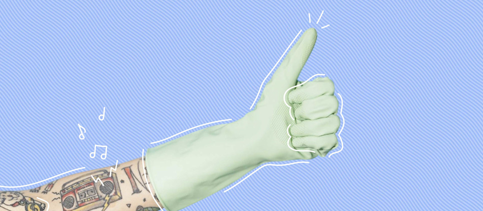 arm with tattoos wearing a mint green rubber glove giving a thumbs up