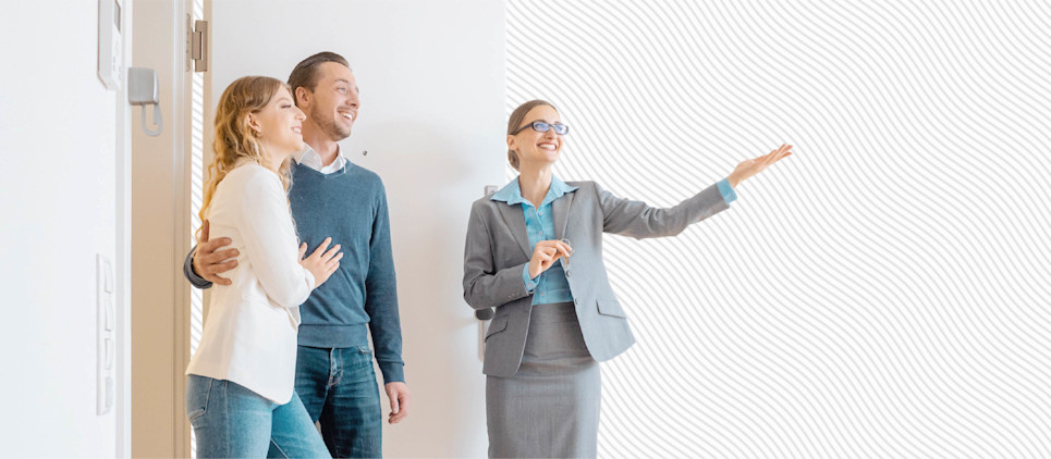 A real estate agent shows a couple property.