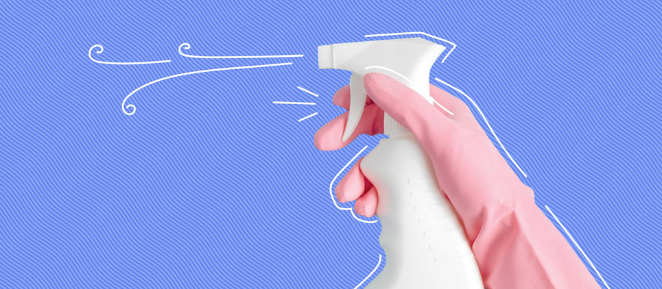 white spray bottle being sprayed on blue background