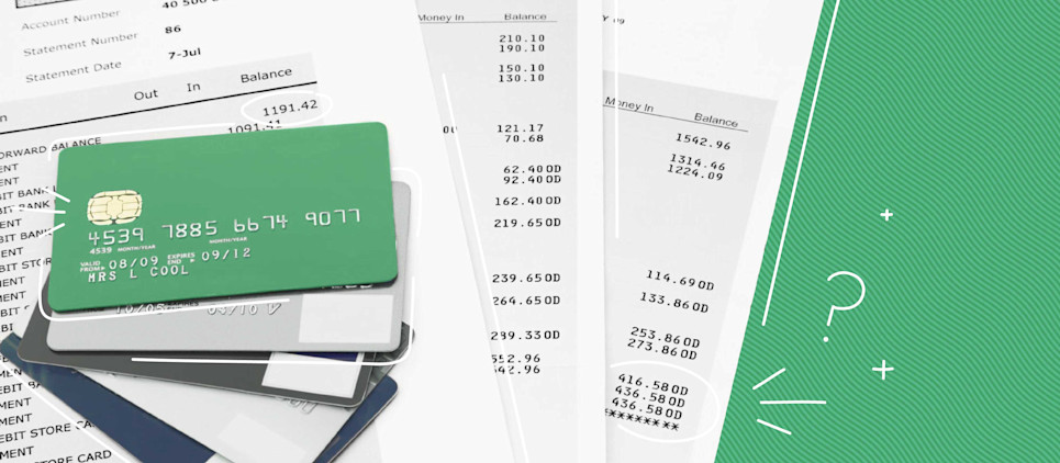 many bills piled with a stack of credit cards laying on top