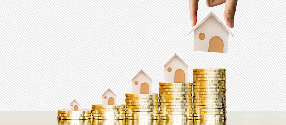 Stacks of gold coins increasing in size from left to right with a miniature houses on top of them.