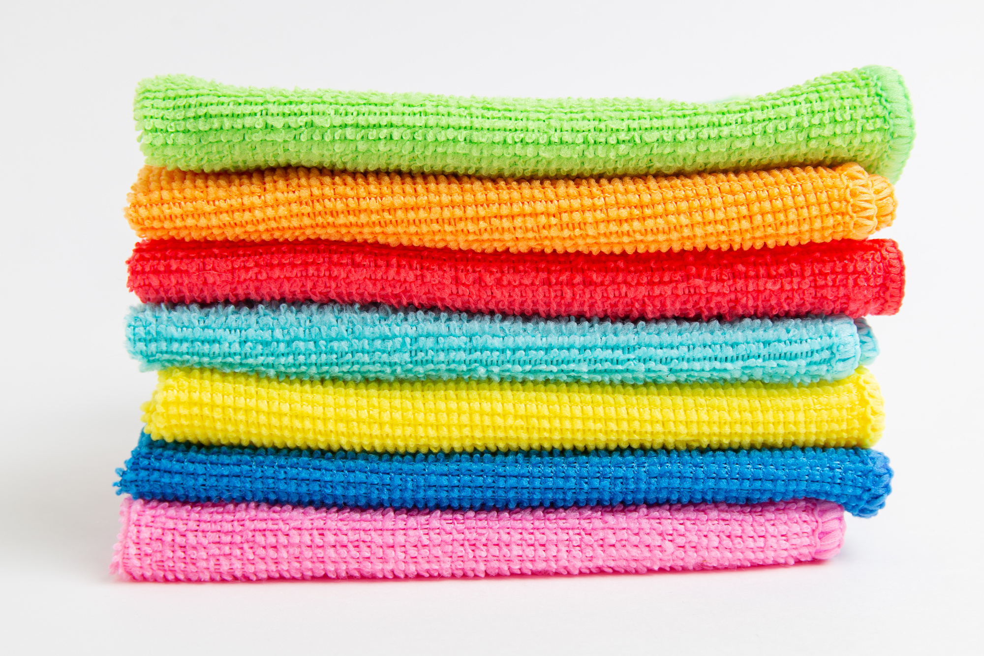 Stack of multi-colored microfiber cloths.