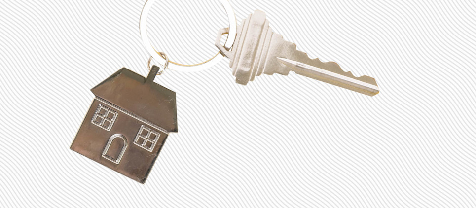 Key and key chain shaped like a house.