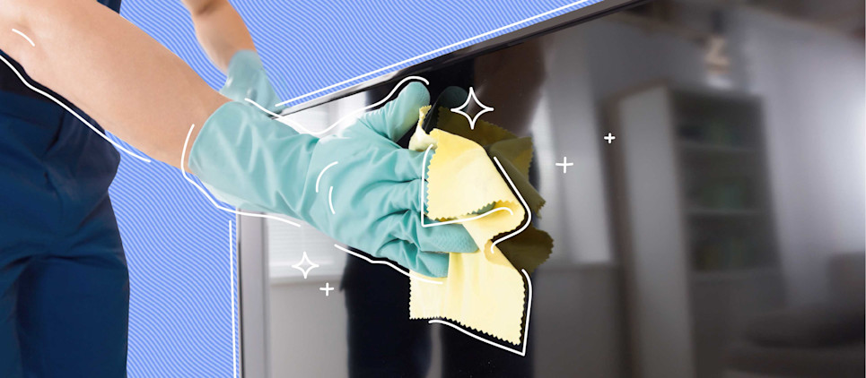 person with light blue glove wiping down tv screen with yellow rag
