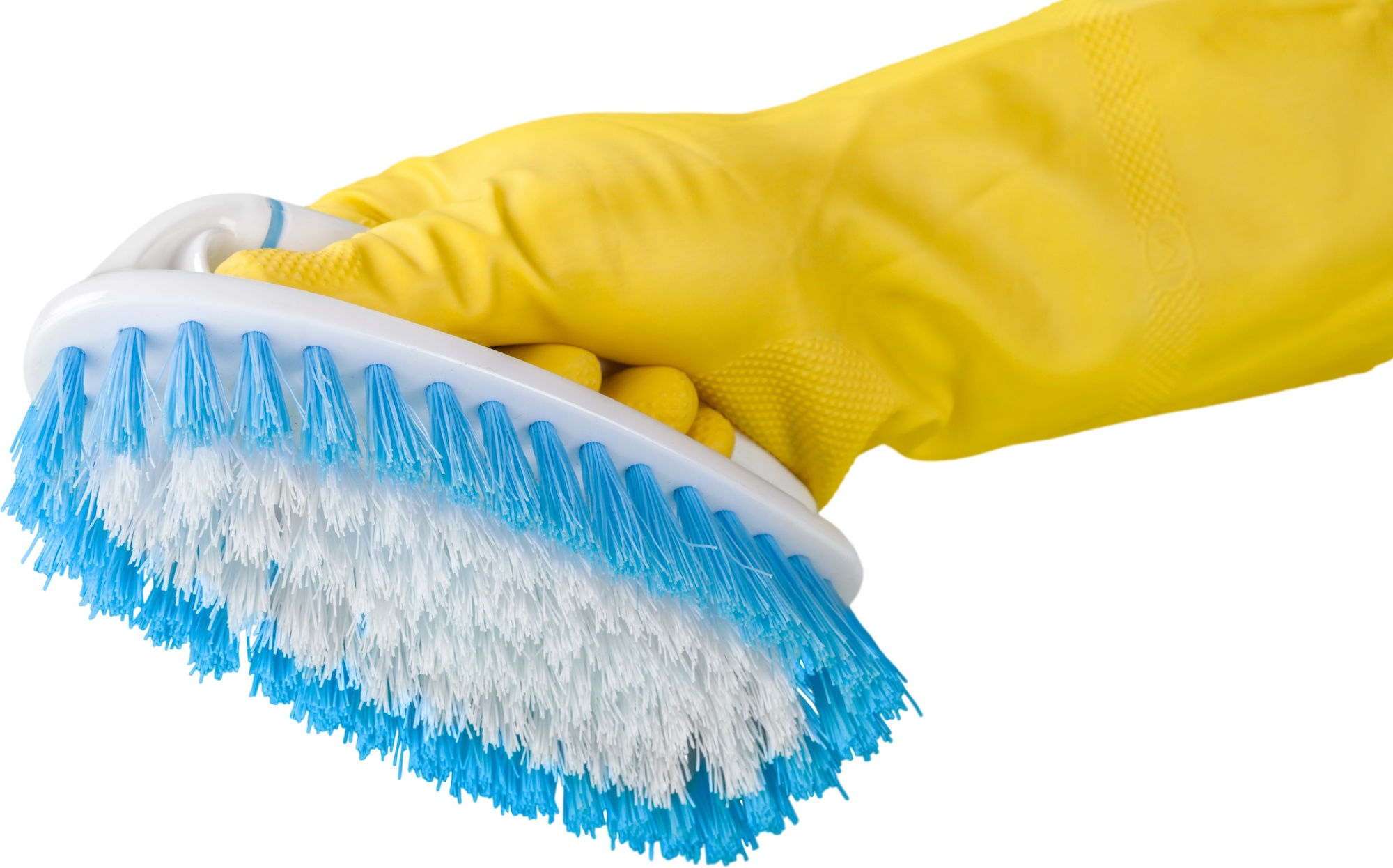 Hand in a yellow cleaning glove holds a scrub brush.
