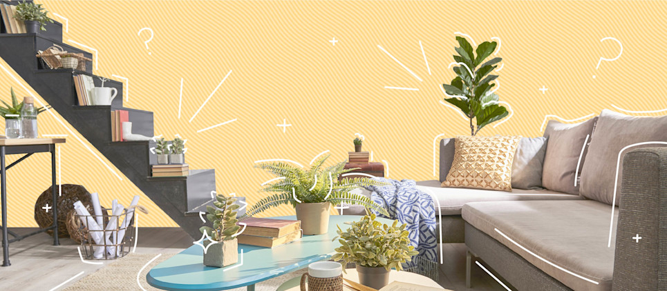 Interior of a decorated micro apartment with a small staircase and a couch.