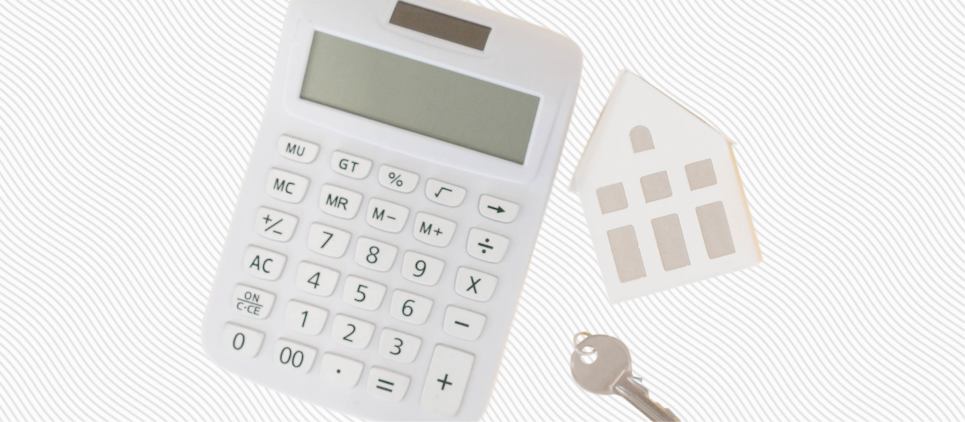 Calculator, a key and a cut out of a house.