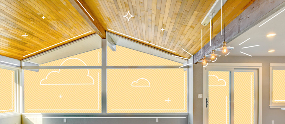 Wooden vaulted ceiling with three pendulum lights hanging and sky in the background.