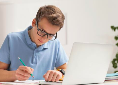 student-glasses-computer-pencil-notetaking