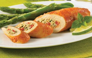 red pepper goat cheese stuffed chicken with asparagus on white plate