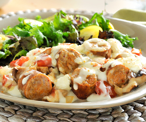 Italian sausage in cream sauce with a salad