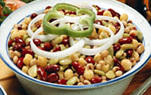 three bean salad with onions and pepper in white and blue bowl