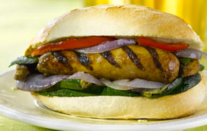 Sausage served in a bun with grilled veggies