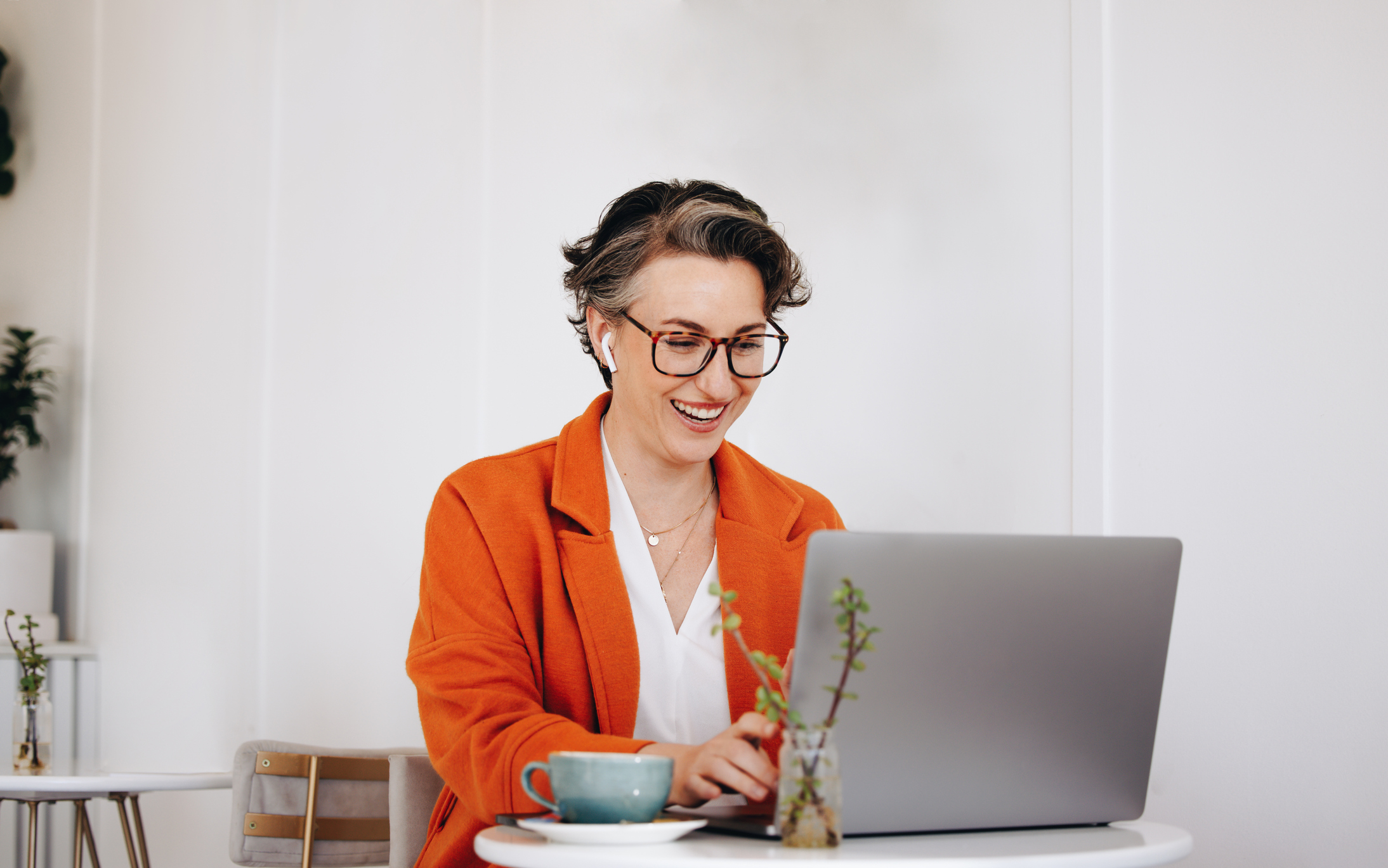 Woman sitting at desk working on laptop doing her taxes