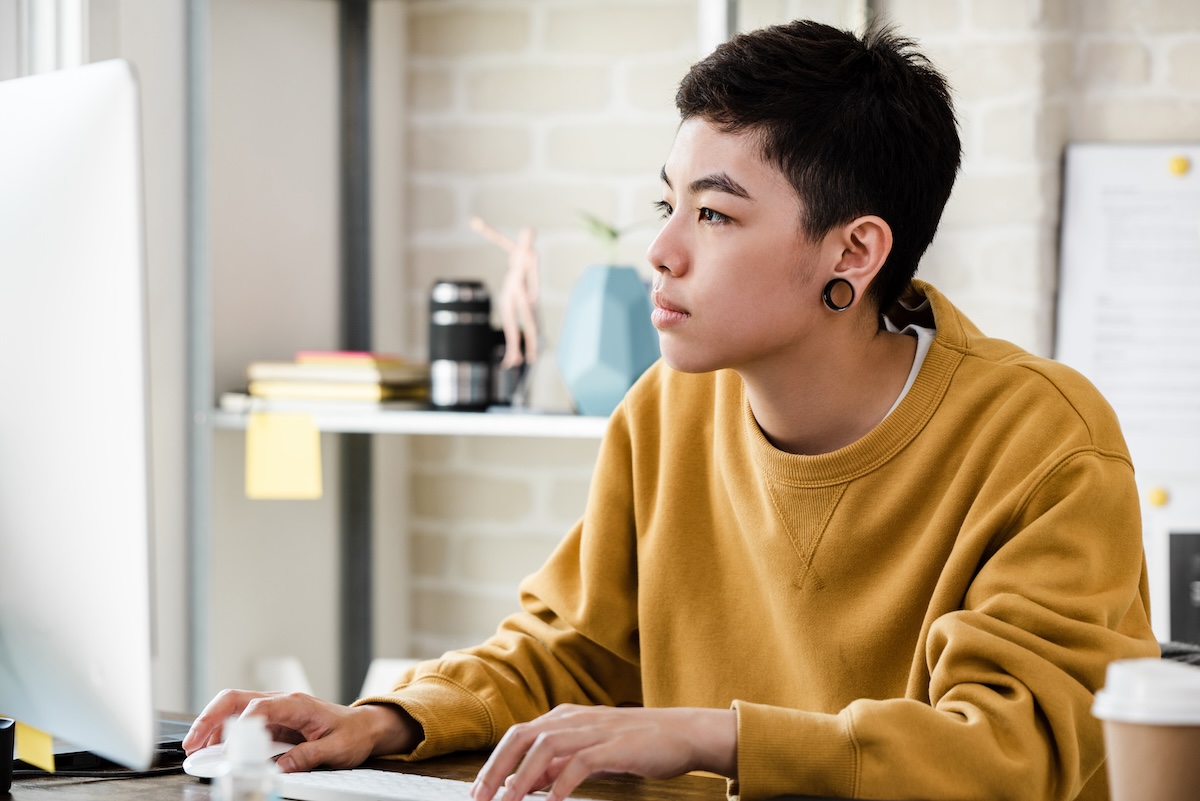 Individual seated in front of a computer looking up eligibility for a HealthEquity Health Savings Account.