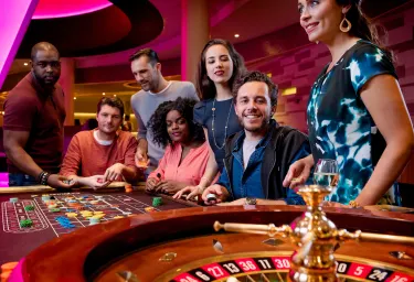 Groep van zeven personen spelen aan een tafel in Holland Casino