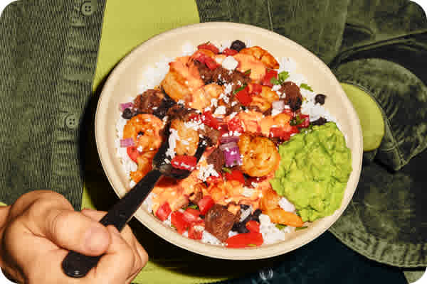 Double the protein, double the flavor with Citrus Lime Shrimp and flame-grilled steak, hand-crafted guacamole, chile crema, pico de gallo, cotija cheese, cilantro lime rice and black beans served in a bowl. Order today QDOBA Mexican Eats.