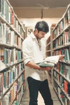 man reading German book in library