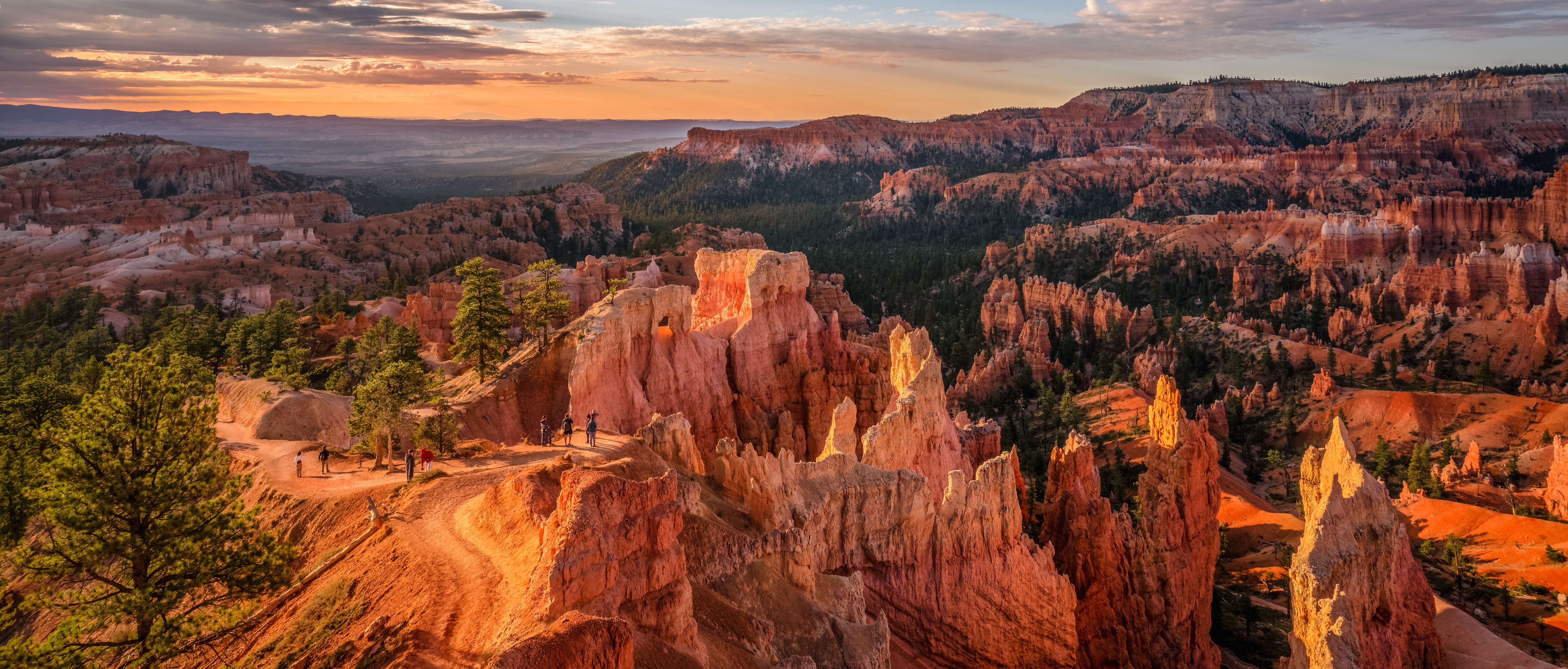 Aerial view of Bryce Canyon and hikers enjoying the trail. 